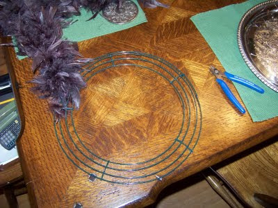 just cut lengths of wire and wired the feather boa to the wreath 